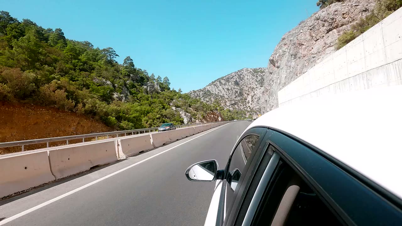 A car driving on a mountain road